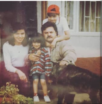 Image of a young Daniela with her mum, dad and sister